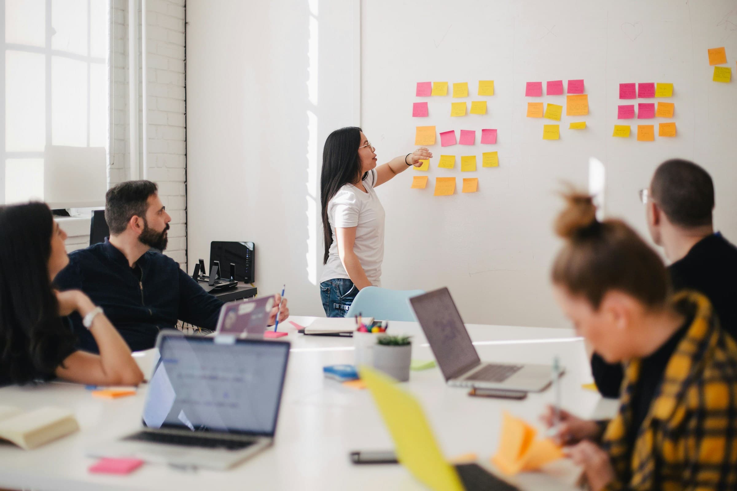 People sharing ideas around a table in a group discussion